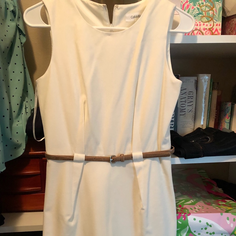 Cream dress with brown belt.